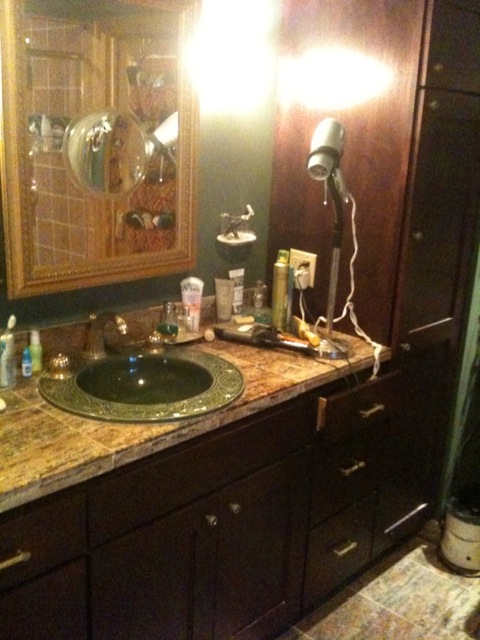 sink with gold medicine cabinet
