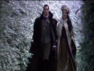 Anne out on a winter walk with Henry in her brown gown and fur cloak and matching hat